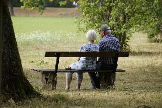 Elderly couple sitting on a park bench