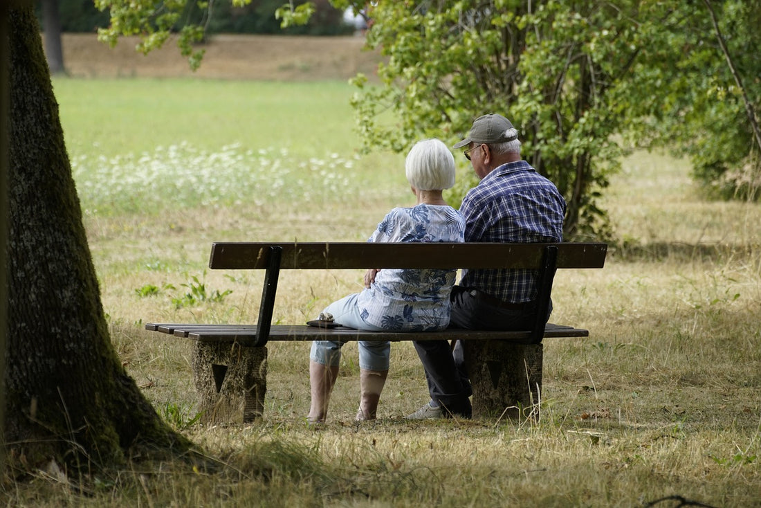 Elderly couple sitting on a park bench